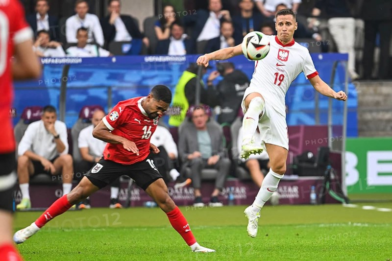 BERLIN, GERMANY - JUNE 21, 2024: Euro 2024 Groupe D match Poland vs Austria 1:3. In action Phillipp Mwene (L) Przemyslaw Frankowski (R)