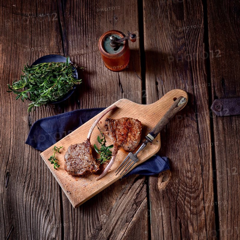 Grilled lamb chops on an old board