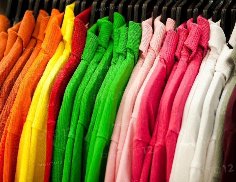 Colorful t-shirts hanging on a rack