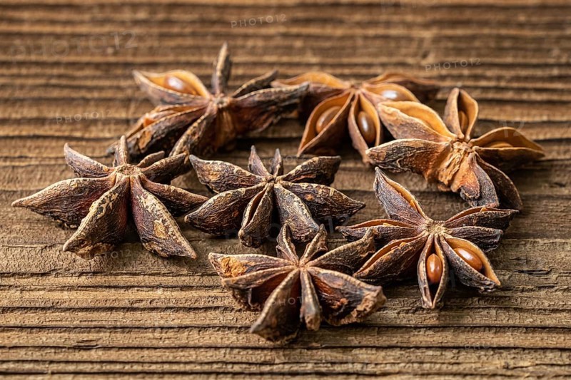 Dried star anise spice on vintage wooden board
