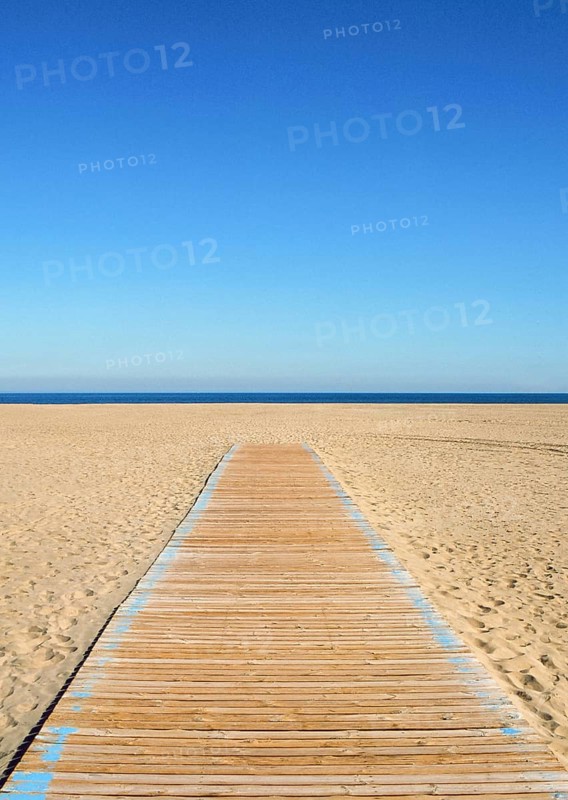 Wooden pathway leading to the beach and sea. Summer scene with clear blue sky
