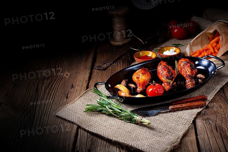 Grilled chicken legs in a barbecue marinade with sweet potatoes