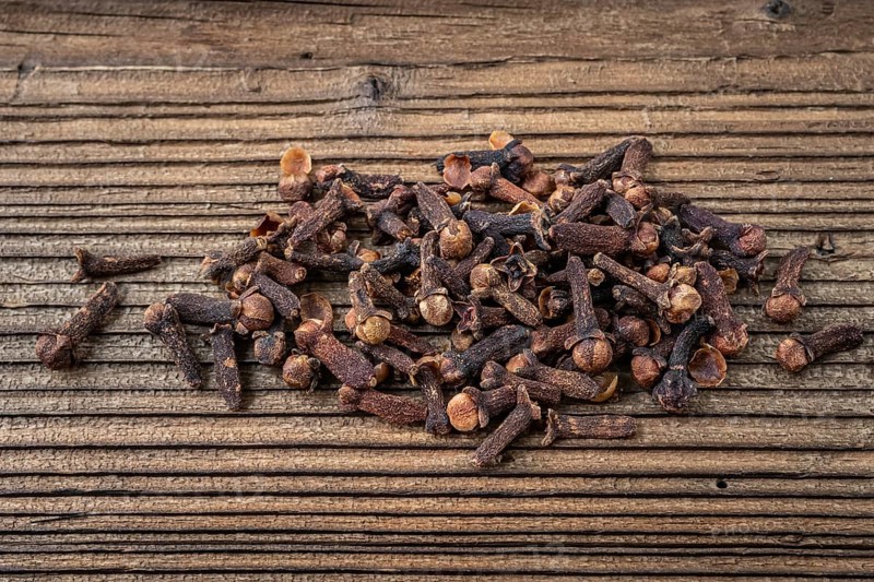 Clove spice on a wooden board, Syzygium aromaticum