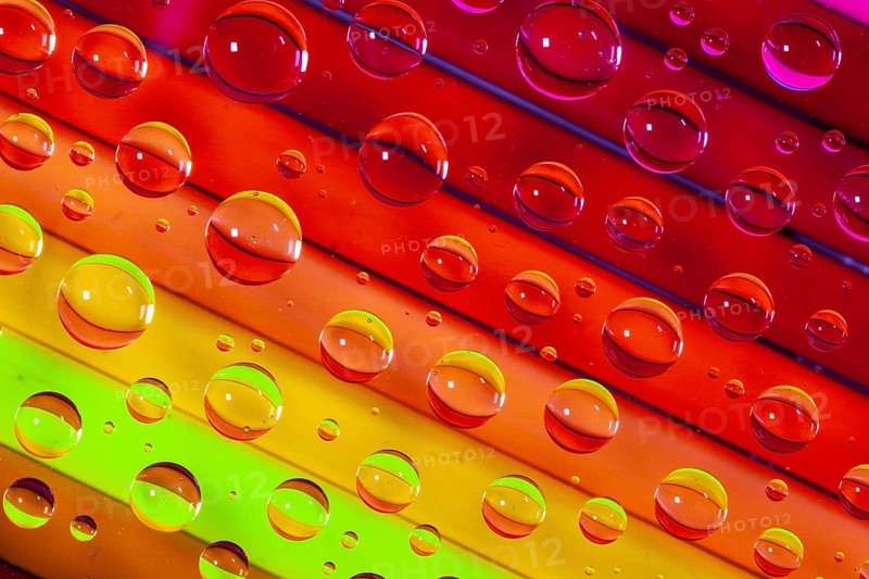 Color pencils under glass with drops of water. Office concept