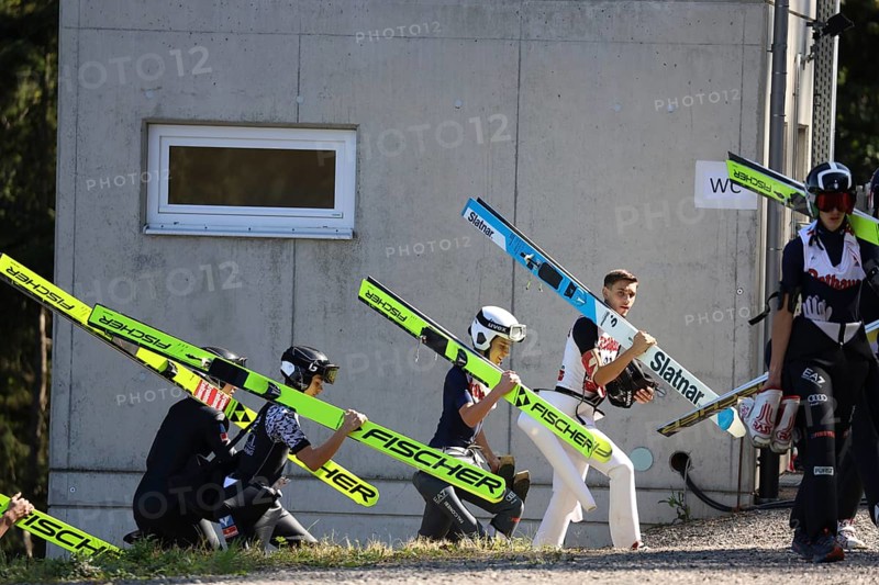 Ski jumpers on their way to the inrun tower at the Alpencup Ski Jumping Hinterzarten 2024, Hinterzarten, Germany / Germany