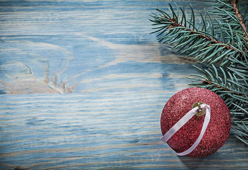 Pine branch Christmas ball on wooden board copy space holidays concept