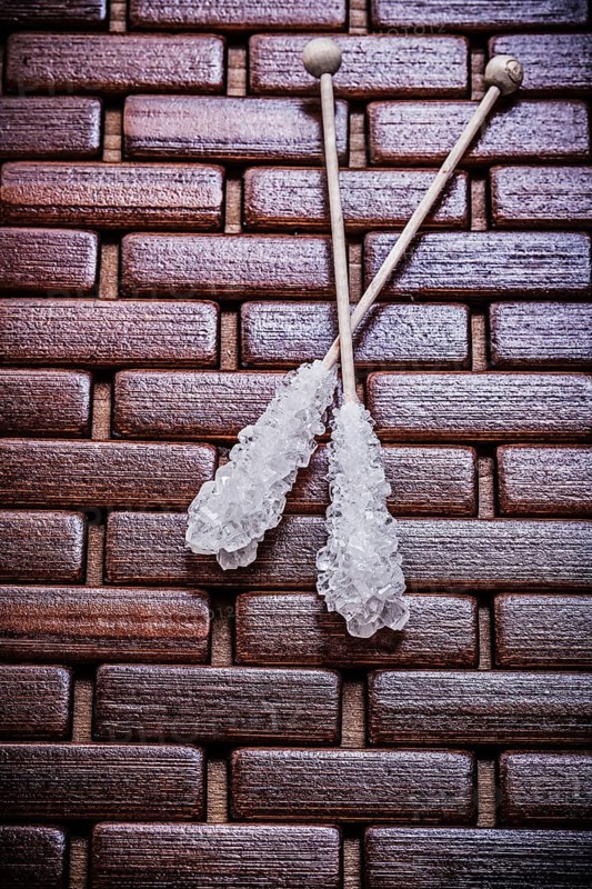 Tasty sugar sticks on wooden matting food and drink concept