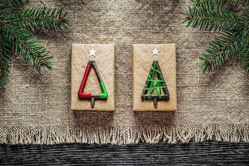 Vintage sacking pine branch Christmas gift box on wooden board