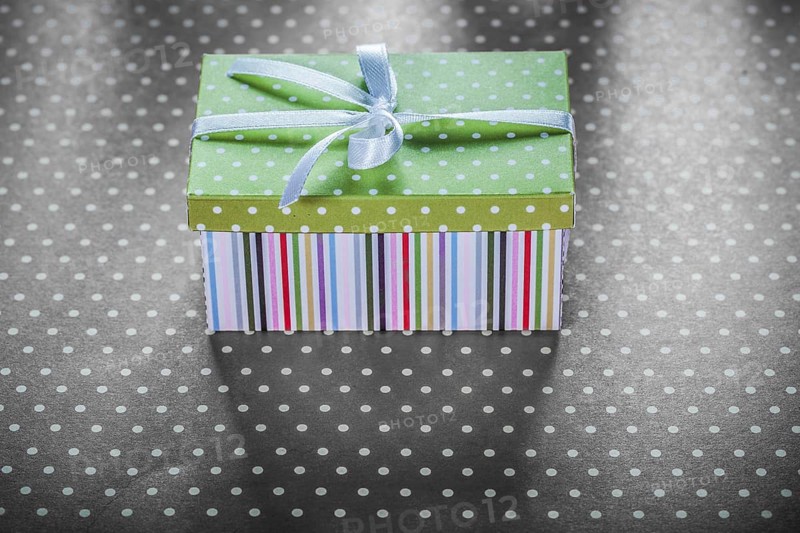 Present box on red tablecloth horizontal image celebrations concept