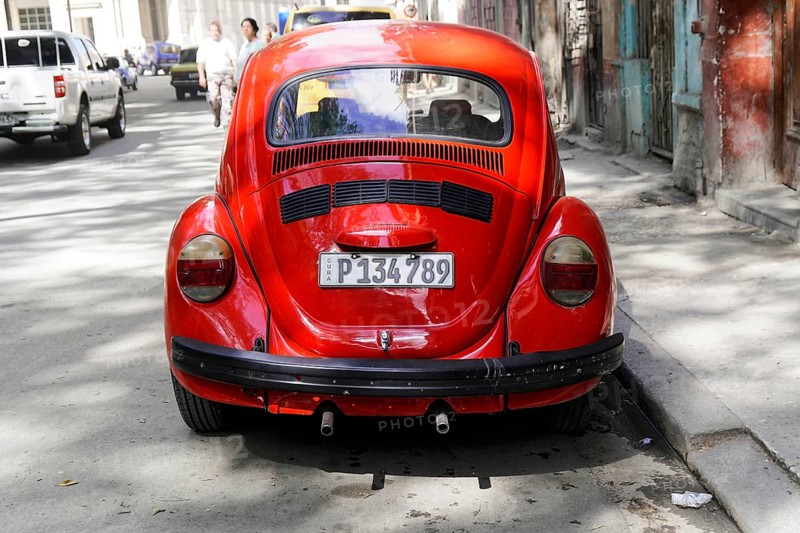Red Volkswagen Beetle on a city street, Cuba, Greater Antilles, Caribbean, Central America, America