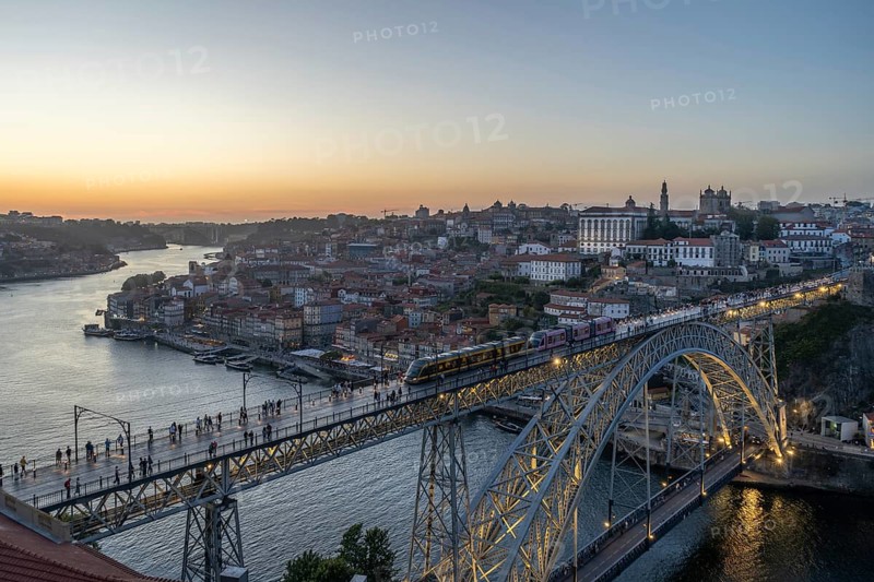 Illuminated Porto City, Douro River and Dom Luis bridge I with Tram. View from Tourist Viewpoint Miradouro da Serra do Pilar at Evening Twilight. Portugal