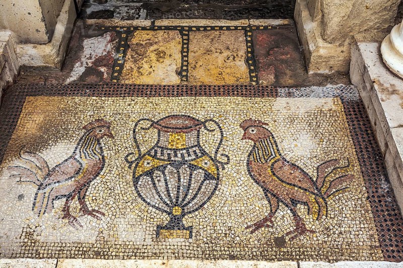 Monastery of Gerasim of Jordan. Picturesque mosaics adorn the entrance to the inner monastery courtyard. Israel. The concept of pilgrimage, religious and photo tourism