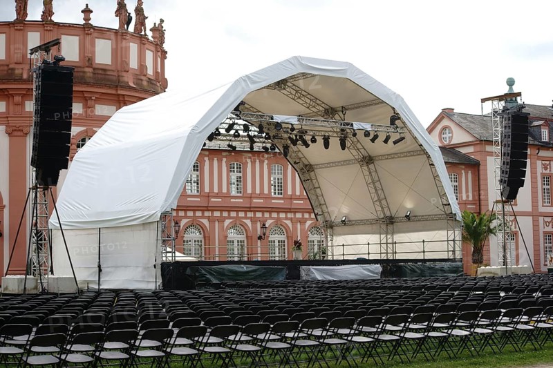 Wiesbaden, Germany - July 14, 2016: A concert stage set up with rows of seats for a classical concert on the palace grounds with Biebrich Palace in the background on 14 July 2016 in Wiesbaden, Germany