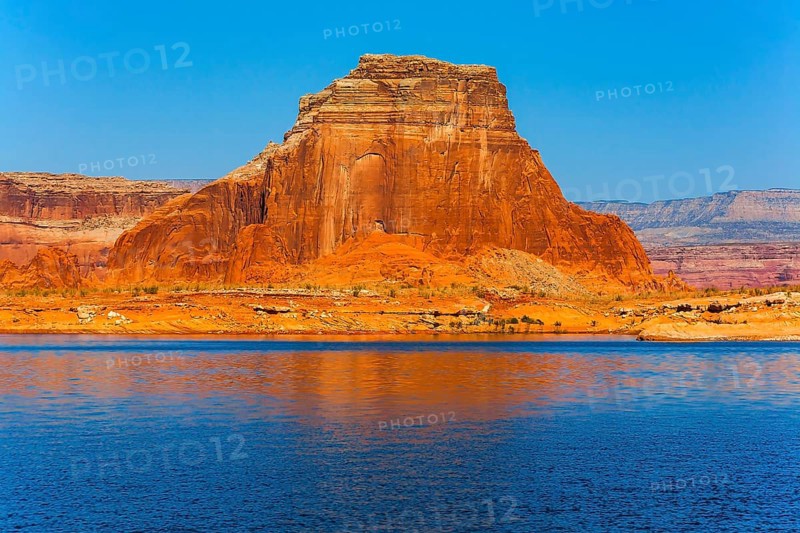 Concept of active and photo tourism. Lake Powell is a reservoir on the Colorado River, USA. Picturesque lake with blue water, among rocks of red sandstone. Great cruise on a passenger boat