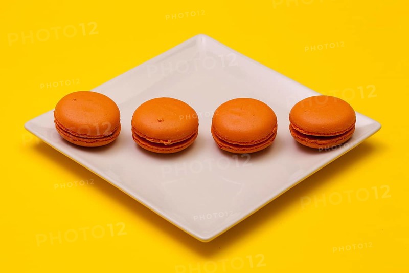 Traditional french colorful macarons on the white plate