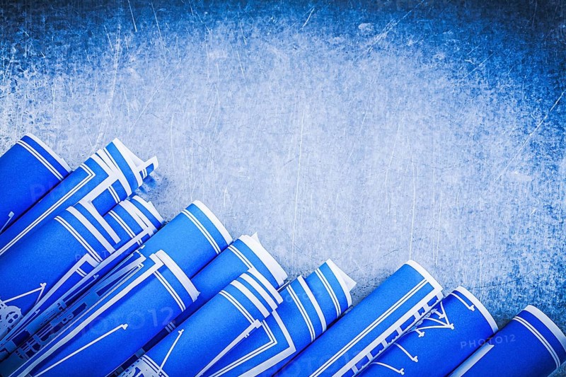 Blue construction drawings on metallic background top view maintenance concept