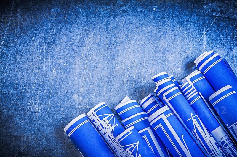 Blue blueprints on metallic background construction concept