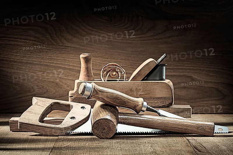 Carpenter tools woodworkers plane wooden mallet chisel handsaw on vintage wooden background