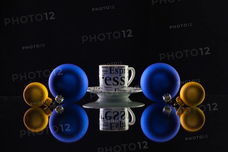 Cup of coffee and Christmas decoration on the glass table