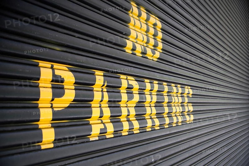 No parking - yellow sign on the garage