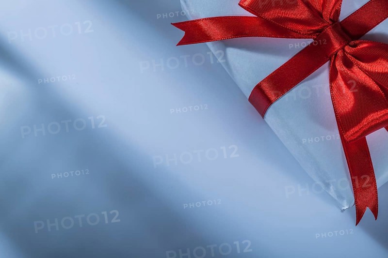 Wrapped red present box on white background