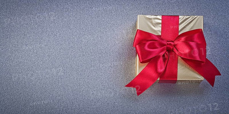 Wrapped box with presents on grey background holidays concept