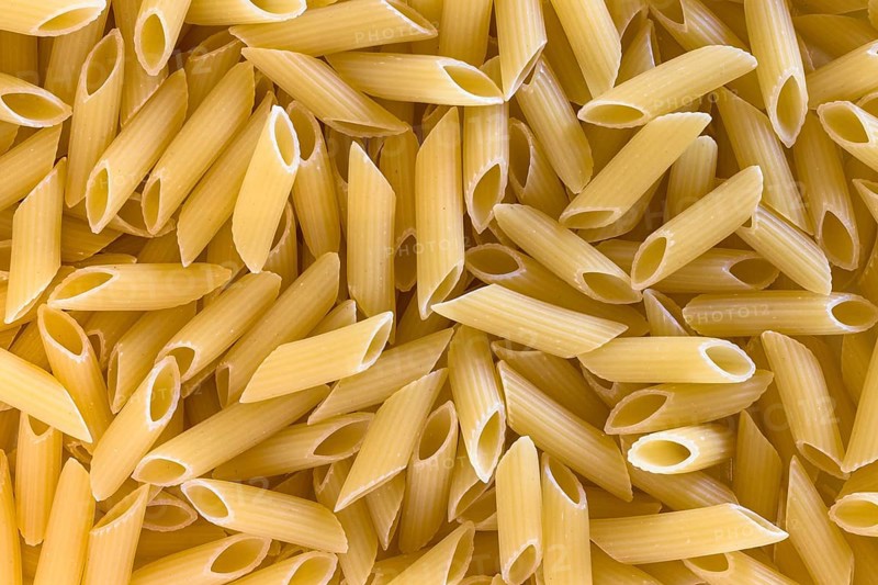 Extreme close up of uncooked italian penne pasta background
