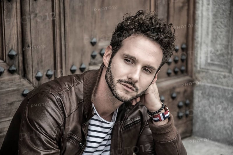Attractive young man outdoor wearing leather jacket, in European city, Turin in Italy