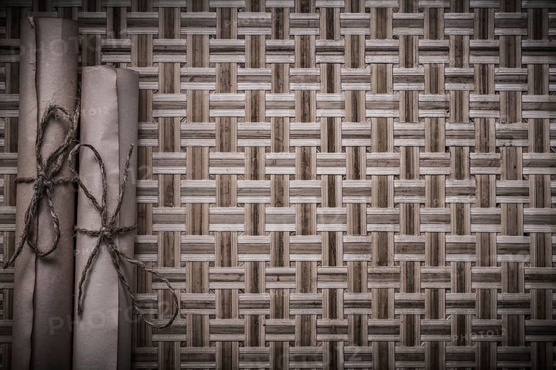 Vintage medieval parchment on wicker wooden surface