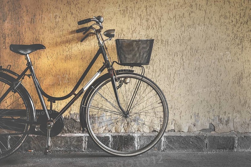 Vintage bicycle leaning against a wall. Retro style photo