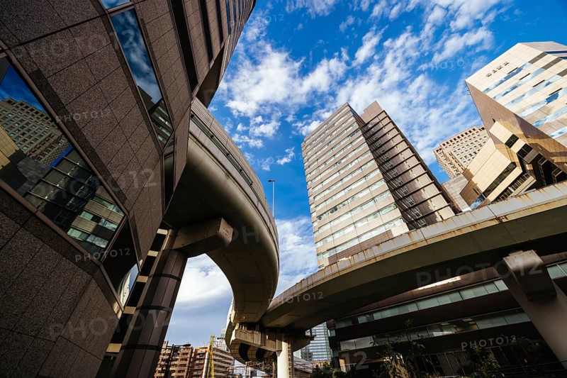 OSAKA, JAPAN - SEPTEMBER 25 2024: The famous 'highway thru a building'. The off ramp for the Umeda Exit of the Ikeda Route of the Hanshin Expressway going thru the Gate Tower Building in Downtown Osaka, Japan