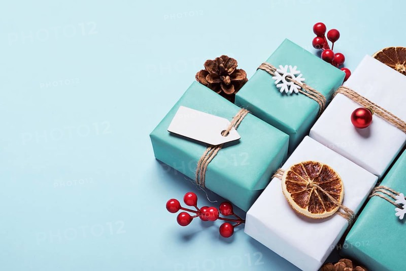 Gifts boxes set packed in paper, decorated with baubles and twine. Eco Christmas decor