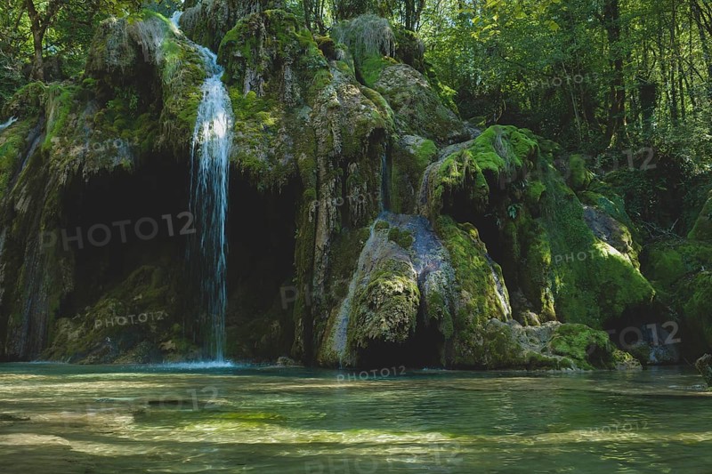 The tufa waterfall near Arbois. Crystal clear waterfall, powerful waterfall