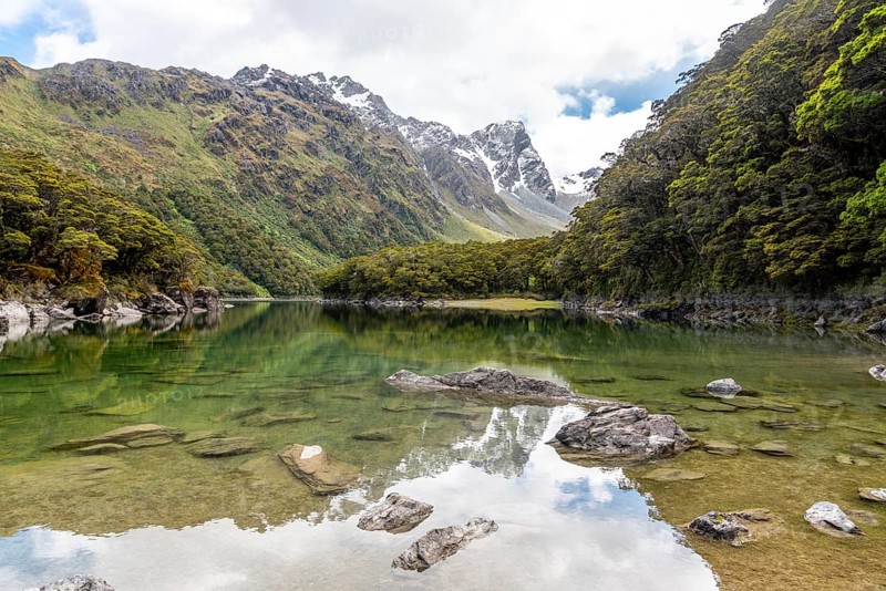 Tranquil mountain lake Mackenzie at the famous Routeburn Track, Fiordland National Park, South Island of New Zealand