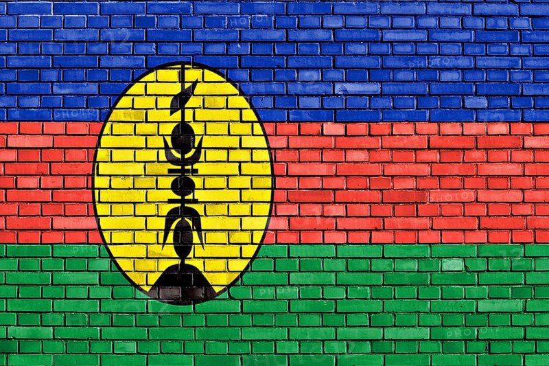 Flag of New Caledonia painted on brick wall