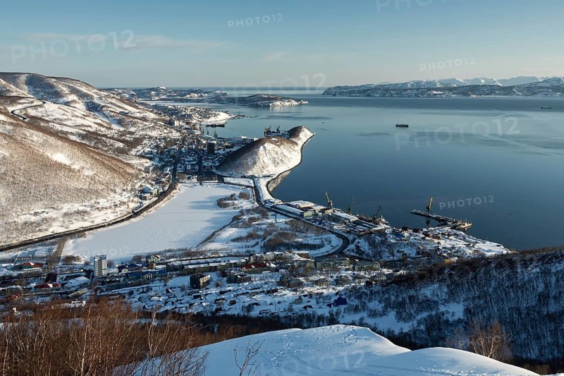 Beautiful winter Kamchatka landscape: top view of the Petropavlovsk-Kamchatsky City, Avacha Bay and Pacific Ocean at sunset. Far East, Russia, Kamchatka Peninsula. (Evening lighting.)