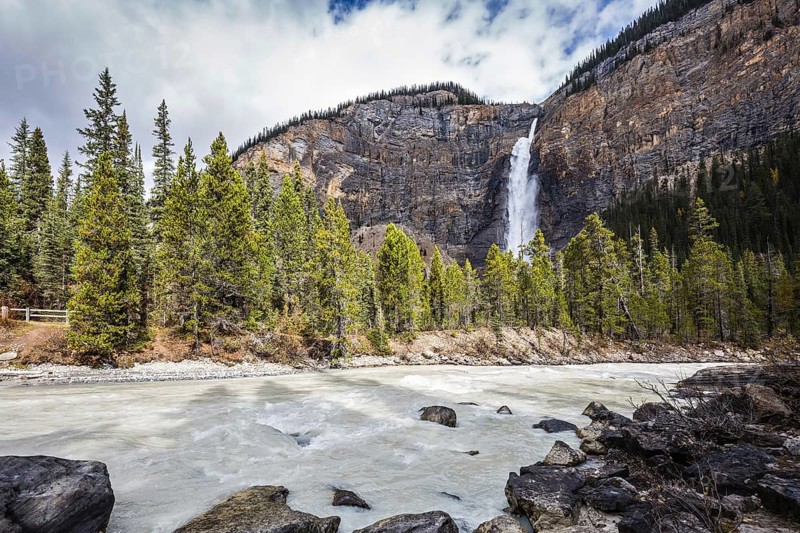 Colossal Takakkaw waterfall formed by melting glacier Daly. Autumn day in Yoho National Park in the Rocky Mountains of Canada