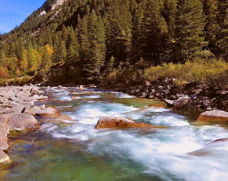 Pastoral in the Alpine mountain valley in Austria. Rapid mountain stream. Cascades of cold water at the source of the famous Krimml waterfalls