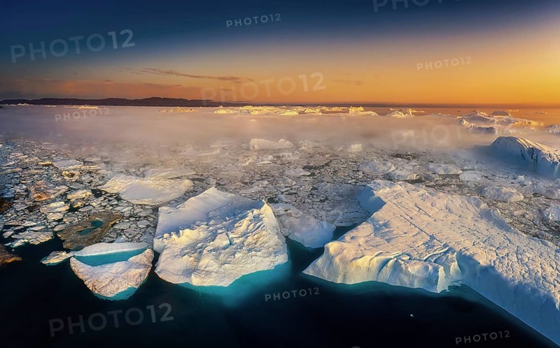 Floating glaciers in the rays of the setting sun during a polar night