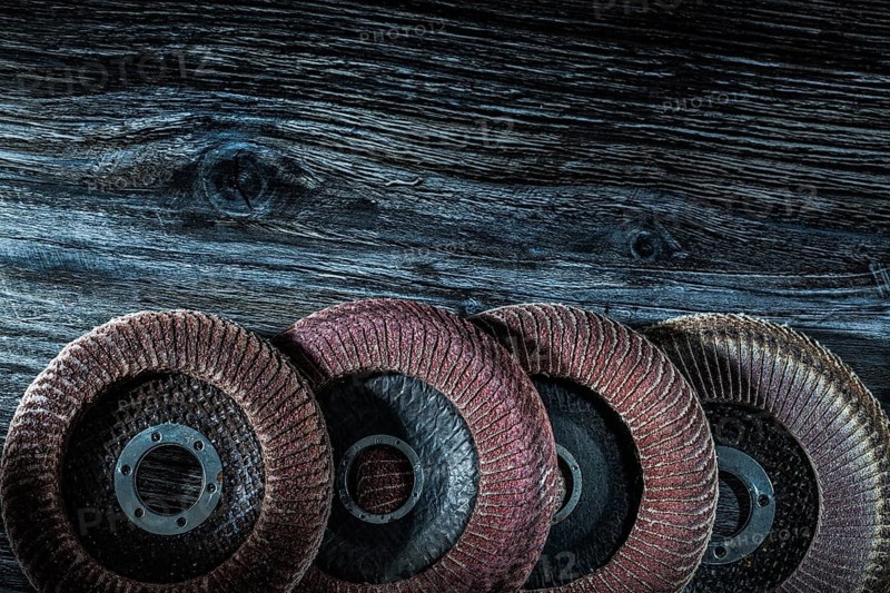 Rotary sanding discs on wooden board