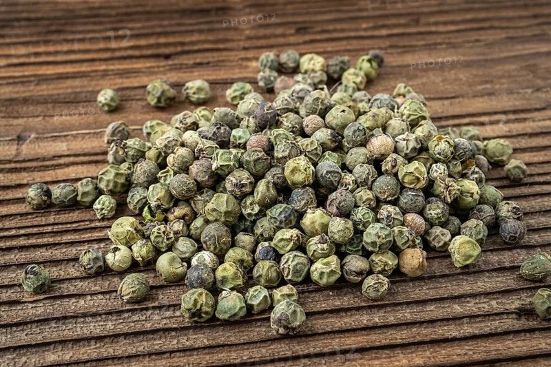 Dried spices green pepper. Peppercorn on dark rustic wooden background