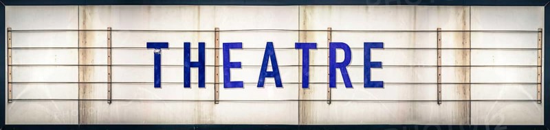 A Grungy Old Weathered Theatre Marquee Sign With Blue Letters
