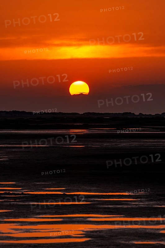 Beautiful golden coloured sunset at the seaside on the Isle Borkum