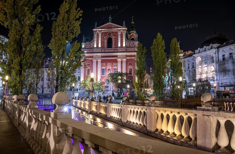 Famous Three Bridges and the Preseren square in the center of Ljubljana illuminated at night, Slovenia