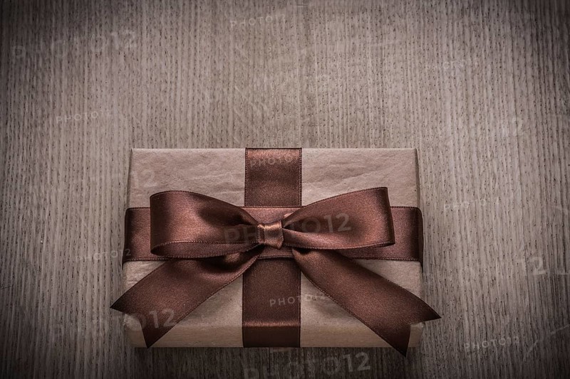 Wrapped vintage present box with tied brown bow celebration concept