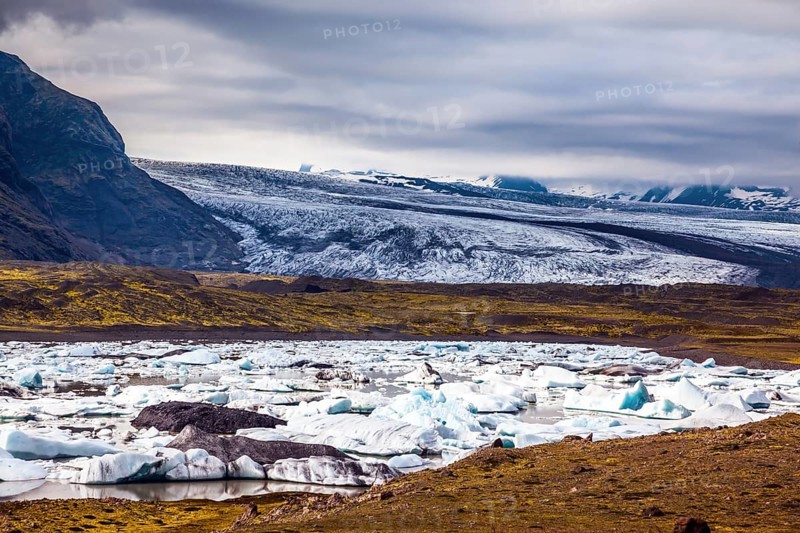 Sunrise in the Ice Lagoon. Drift ice Ice Lagoon - Jokulsarlon. Ice floes are reflected in the smooth water surface. The concept of extreme northern tourism