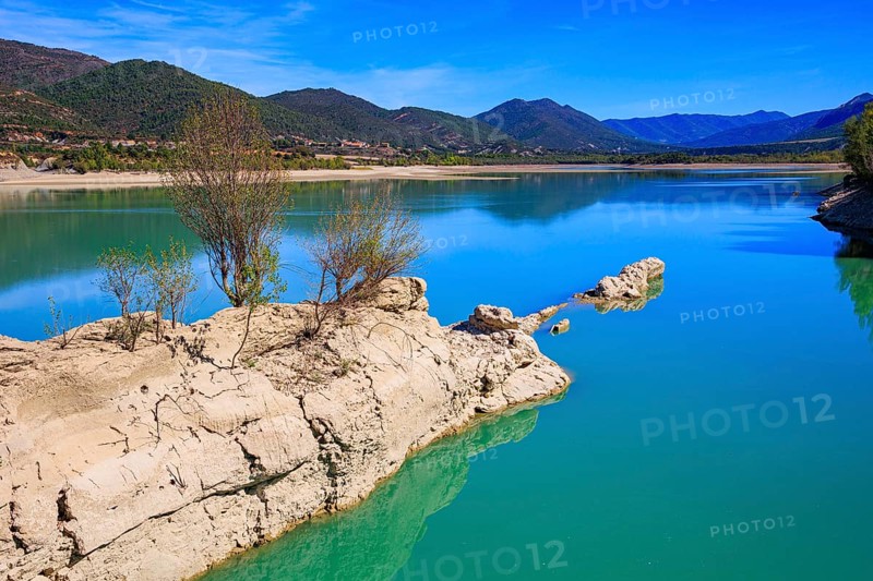 Picturesque backwater. Wonderful autumn day. The La Penia Reservoir collects the waters of the Gallego River. Indian summer in northern Spain
