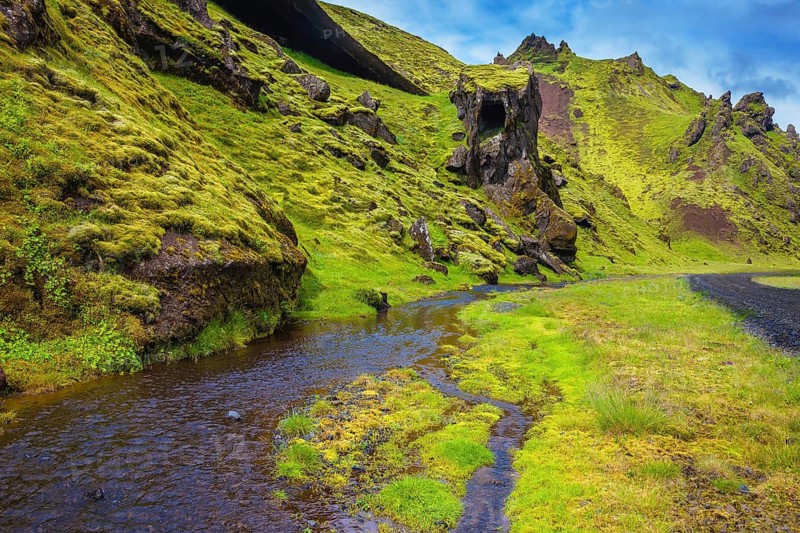 Picturesque basalt hills covered with green grass and moss-polar. At the bottom of the canyon flowing streams lot. Canyon Pakgil in Iceland