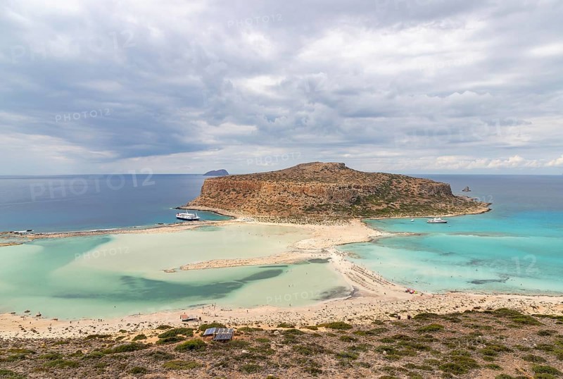 A picture of the blue water of Balos Beach and the nearby landscape of the Gramvousa Peninsula