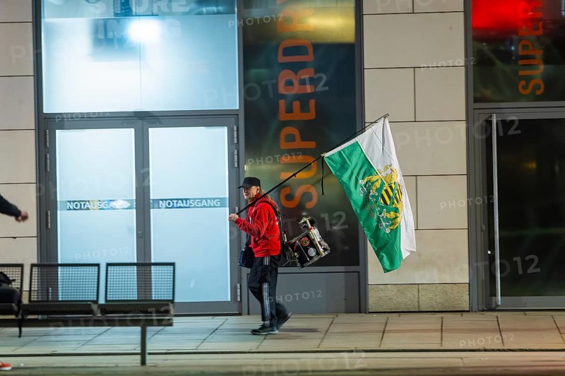 A supporter of the radical Free Saxons, walks with a Saxon flag and drum on Wilsdruffer Straße for the Monday demonstration, Dresden, Saxony, Germany